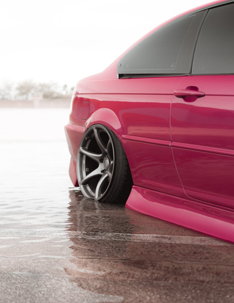 Pink Car with Flat Tire During Flooding